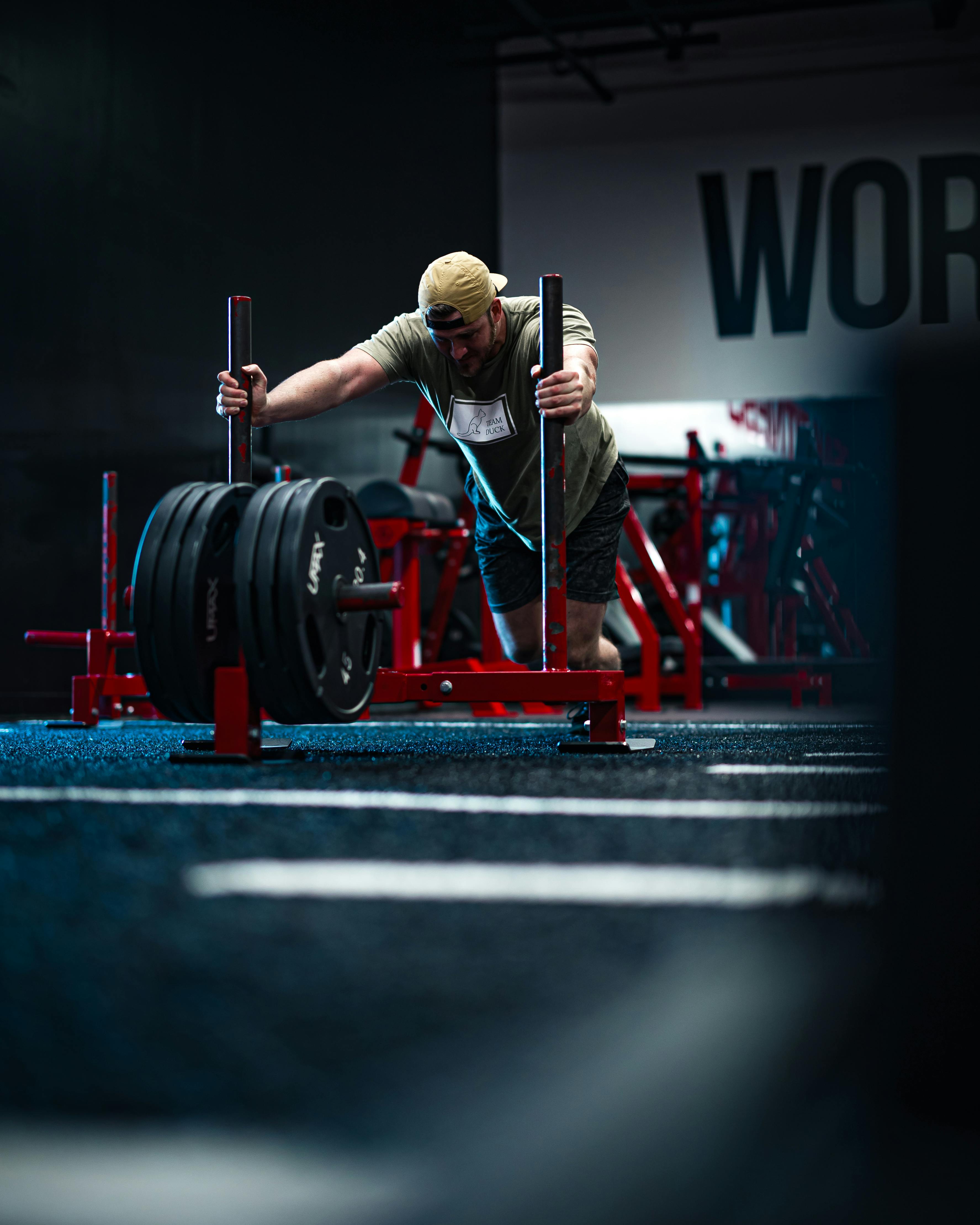 Athlete pushing a weighted sled during strength training
