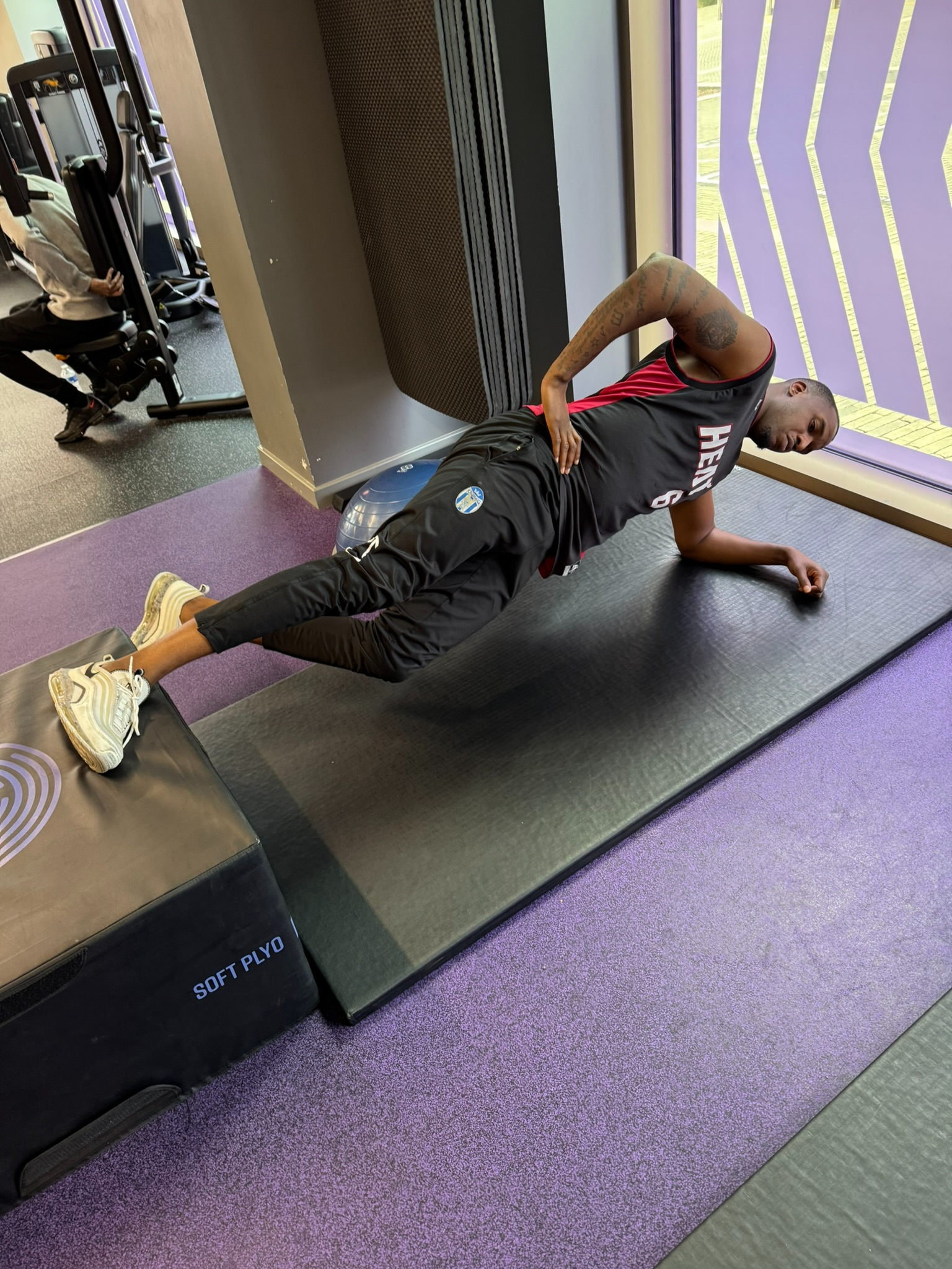 Michael Ngoo performing a side plank during football performance training