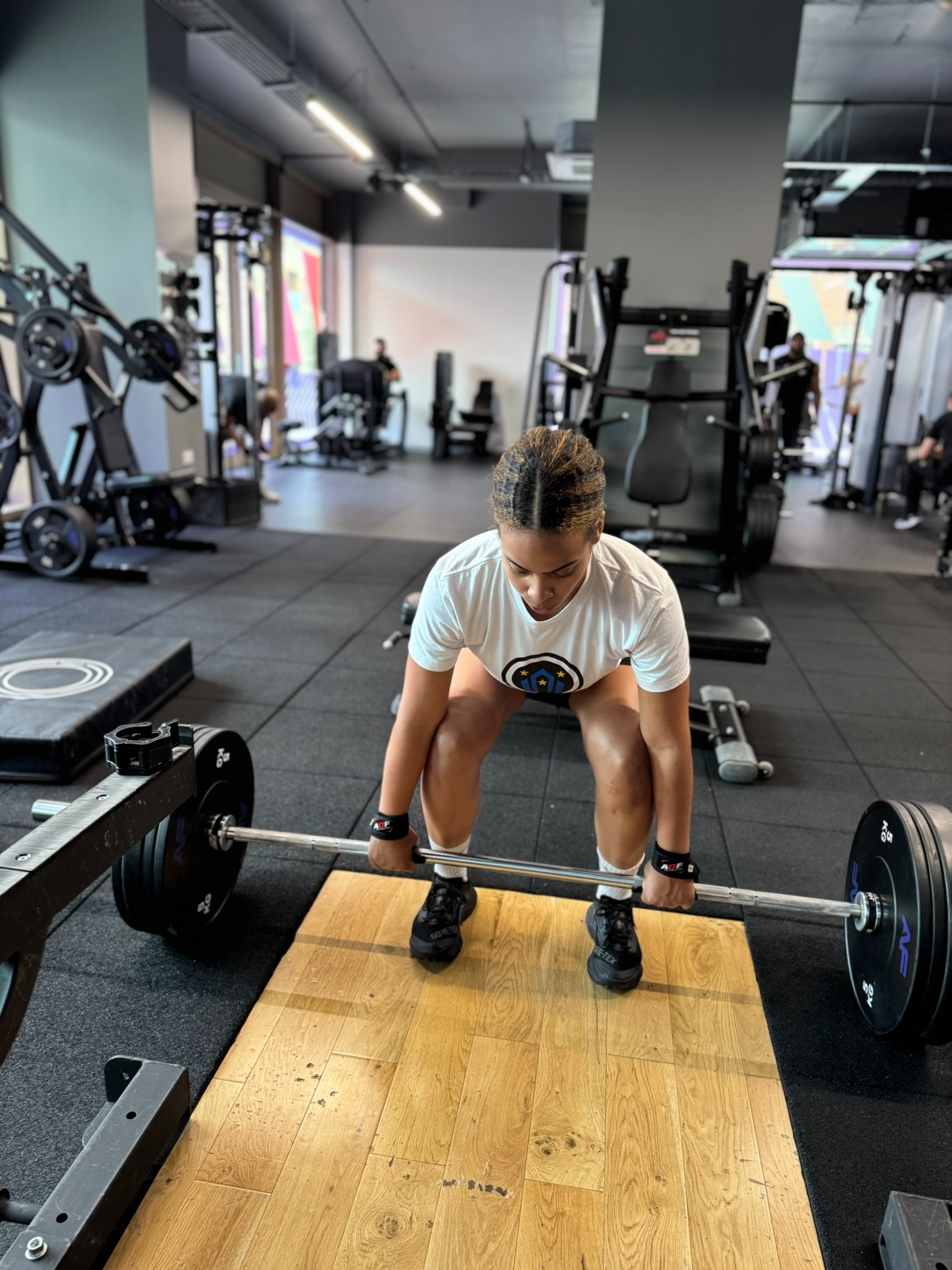 Client performing a deadlift during a coached strength session